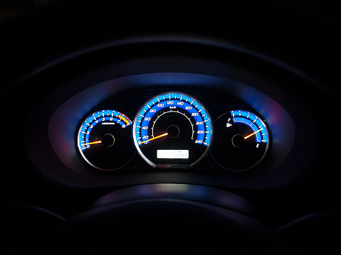 Sports car dashboard at night.