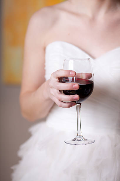 Bride holding glass of wine stock photo