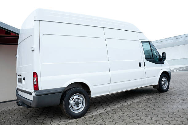 Parked blank white Van side view of a white tranporter, isolated on white transporter stock pictures, royalty-free photos & images