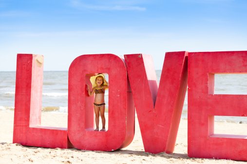 A little girl playing at the beach.