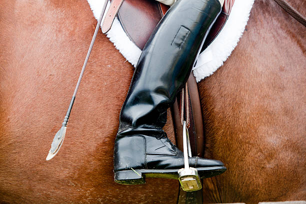 Riding Boot in Horse Competition Riding Boot in the stirrup in Horse Competition dressage stock pictures, royalty-free photos & images