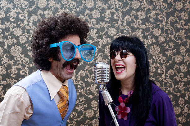 Two friends in seventies style singing on old fashioned microphone
