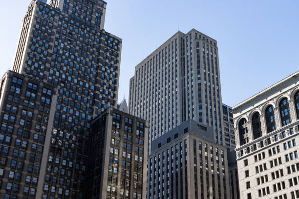 Looking up at a variety of old brick and stone skyscrapers in downtown Chicago