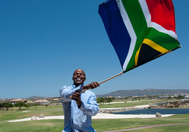 Man Waving South African Flag Man Waving a South African Flag south africa flag stock pictures, royalty-free photos & images