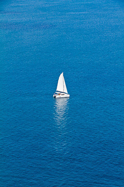 Lonely Sailboat Lonely sailboat in the calm waters of the Caribbean Sea, north of Saint Lucia. tobago cays stock pictures, royalty-free photos & images