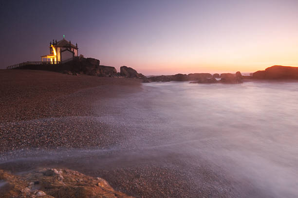 Chapel at Sunset Photo of the Senhor da Pedra Chapel in Vila Nova de Gaia, Portugal, at Sunset. Film and grain simulation on processing. Neutral Density Graduated filter, wide angle lens and long exposure at picture taken. vila nova de gaia stock pictures, royalty-free photos & images