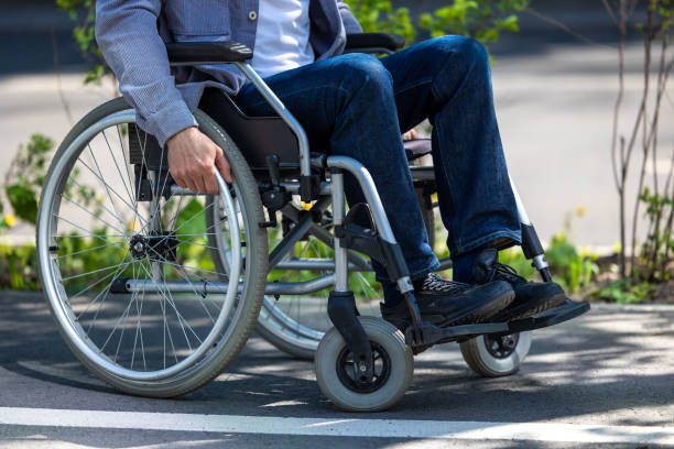 istock Unrecognizable man on wheelchair in park. 1553614707
