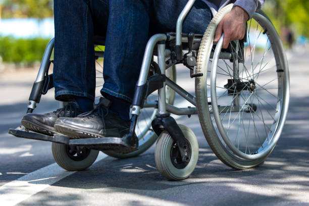 istock Unrecognizable man on wheelchair in park. 1553614711