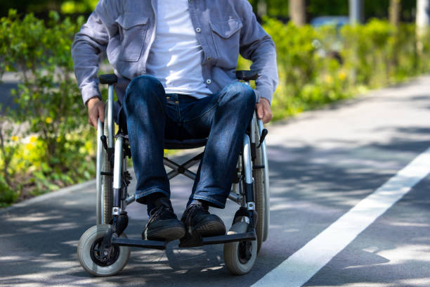 istock Unrecognizable man on wheelchair in park. 1553614717