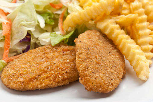 Breaded Chicken Breastsalad, and French Fries Close up