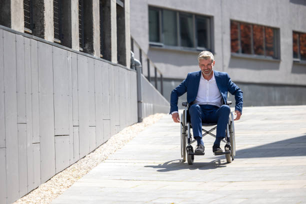 istock Disabled handsome man on wheelchair outdoor. 1553616468