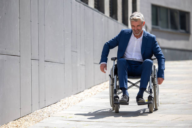 istock Disabled handsome man on wheelchair outdoor. 1553616476