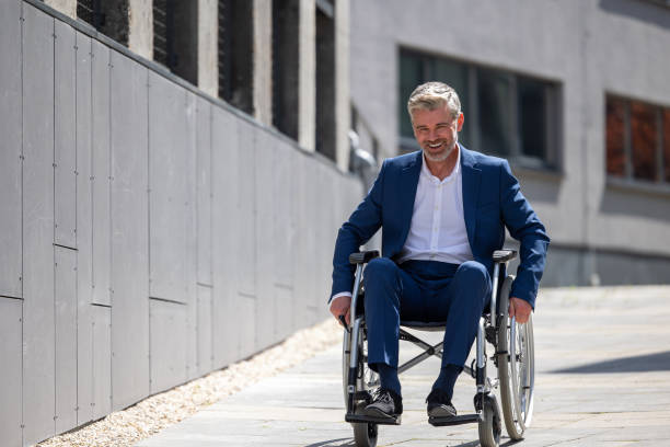 istock Disabled handsome man on wheelchair outdoor. 1553616484