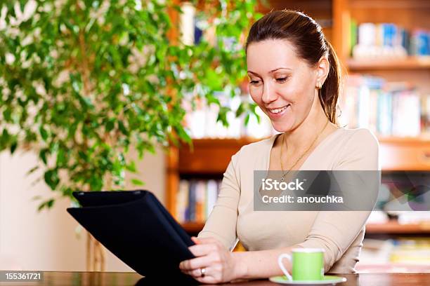 Smiling Woman Using Digital Tablet And Drinking Coffee At Home Stock Photo - Download Image Now