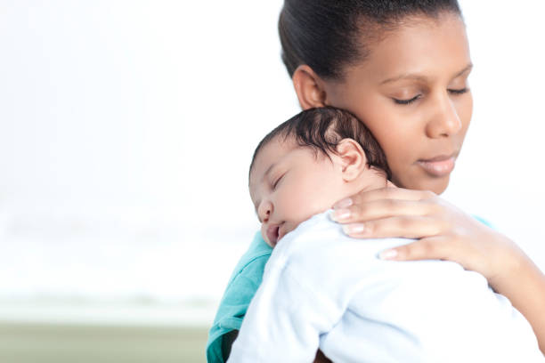 istock Mother relaxing her newborn baby. 155361767