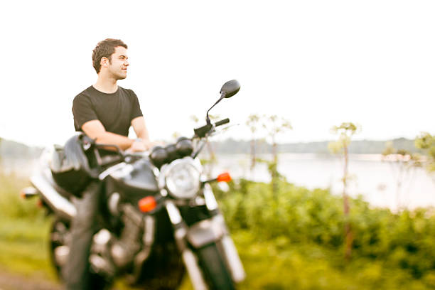 Smiling biker stopping for a break. Tilt-shift used, focus is on face. 