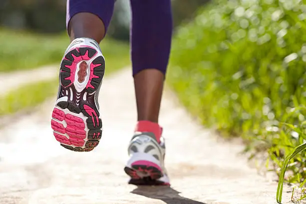 Close-up of women's sport shoes running outdoors.