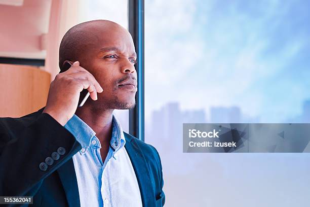 Businessman On The Phone Stock Photo - Download Image Now - Horizon, Looking, Looking Through Window
