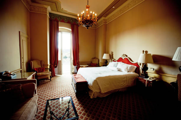 Hotel room door open. Clean and elegant accommodation service. Close up of handle. Bed, table and tv. Travel, lodging and motel concept.