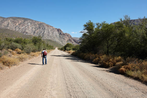 istock Man hiking on mountain pass dirt road 155362228
