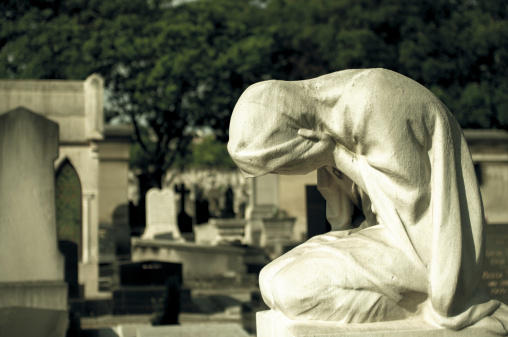 Statue of weeping woman on a grave, Paris, France