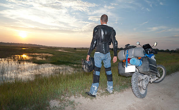 istock motorcycle rider stops to enjoy sunrise 155368043