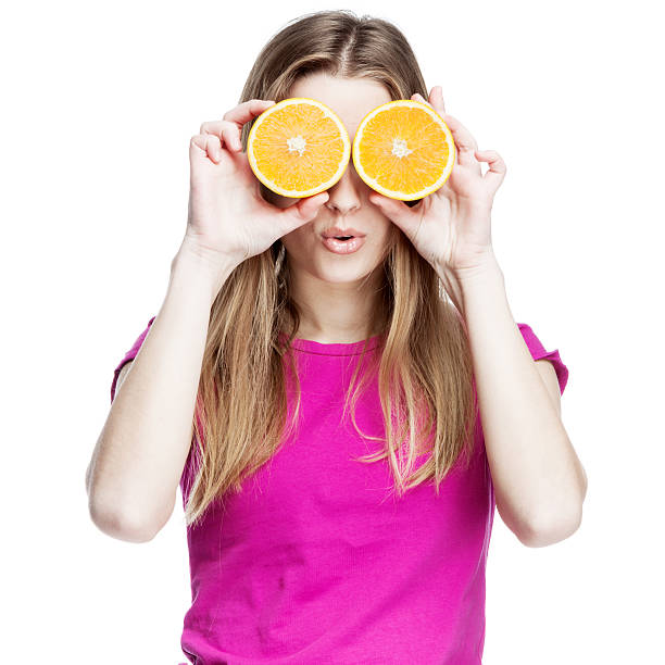 istock young beautiful blond woman holding orange 155368082