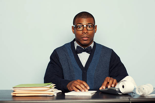 Nerdy Accountant A young accountant is ready to crunch your numbers this tax season. black nerd stock pictures, royalty-free photos & images