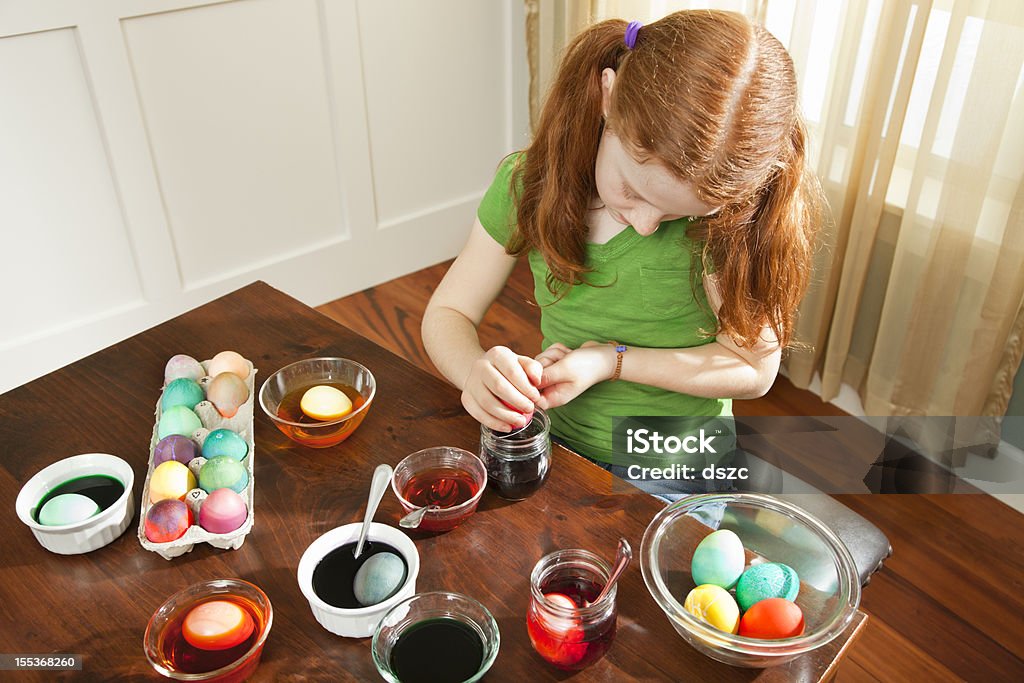 Red-head Little Girl Dyeing Easter Eggs 6-7 Years Stock Photo