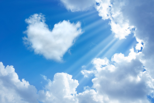 heart shaped cloud in cloudy sky  and sunbeam.