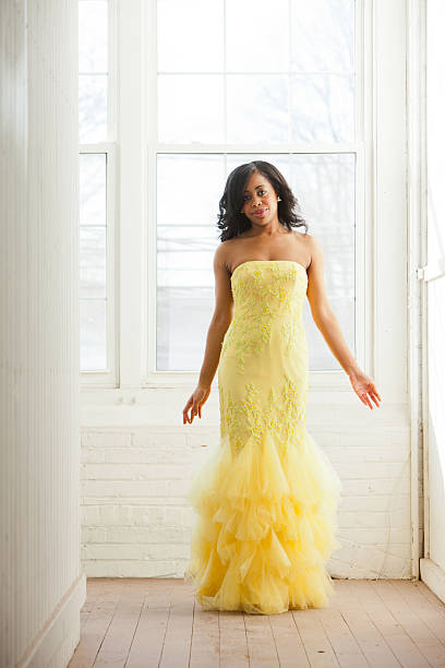 Beautiful woman in a yellow evening dress  prom dress stock pictures, royalty-free photos & images