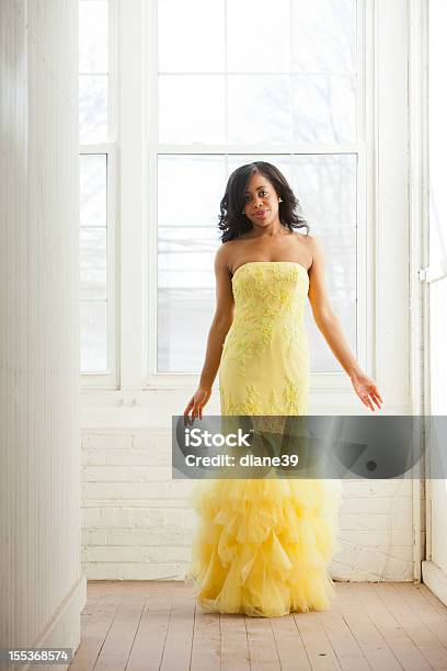 Beautiful Woman In A Yellow Evening Dress Stock Photo - Download Image Now - Prom Dress, Yellow, Dress