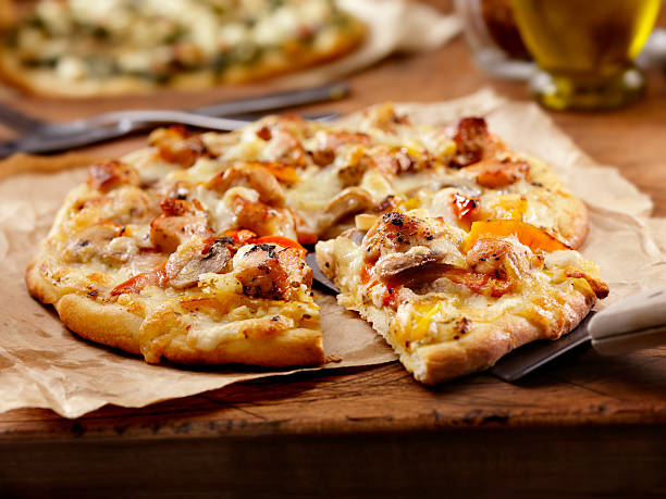 Grilled Chicken and Roasted Pepper Pizza Authentic Italian, Hand Made Grilled Chicken and Roasted Pepper Pizza with a Creamy Garlic Alfredo sauce- Photographed on a Hasselblad H3D11-39 megapixel Camera System flatbread stock pictures, royalty-free photos & images