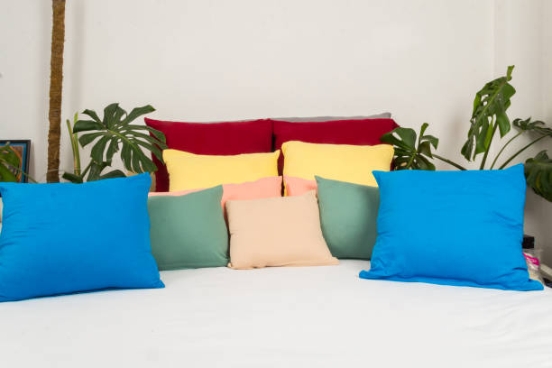 istock colored pillows on white bed in natural bedroom interior 1553691337