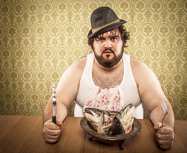 Large Bearded Man Eating Bowl of Fish Heads, Undershirt  grotesque stock pictures, royalty-free photos & images