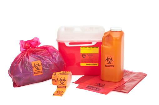 This image shows various forms of bio-waste including needle disposal container, liquid bodily waste, and bagged medical waste...all with bio-waste warnings. Background is 255 white with clipping path.