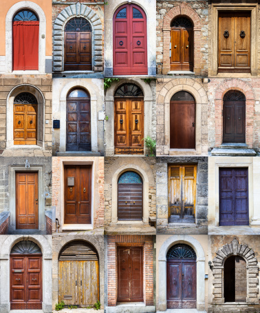 Twenty wooden doors in different size, shape and colors. Location: Tuscany, Italy.