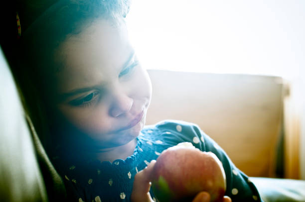 istock Child (5-6) Is Eating an Apple at Home 155370007