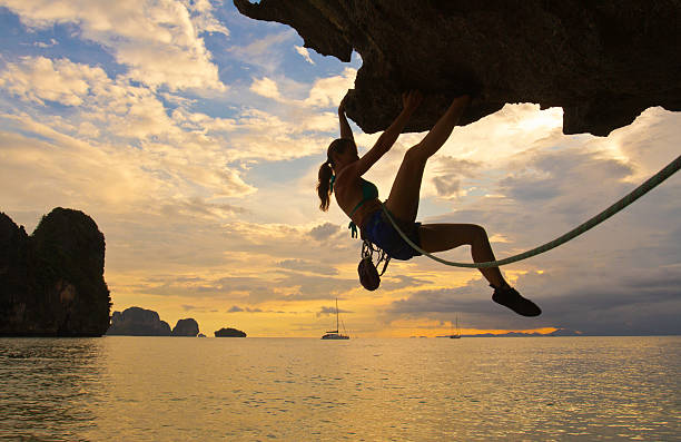 Woman rockclimbing silhouette stock photo