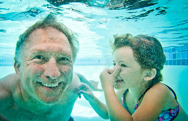 Grandpa and Granddaughter Underwater