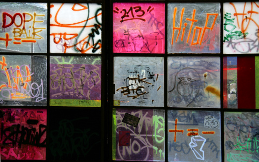 Graffiti on windows in old house in Berlin named Kunsthaus Tacheles. It's an art center and nightclub opened in spring 1990 in East Berlin after the Berlin Wall came down . Tacheles is a large (9000 square meter) building on Oranienburger Strasse. Kunsthuar Tacheles was closed  4. of September by the owner of the building. Very sad story for many artist's and visitors. Similar: 