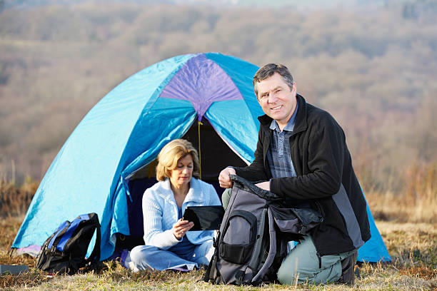 Mature Couple Camping A portrait a mature couple camping. ashdown forest photos stock pictures, royalty-free photos & images