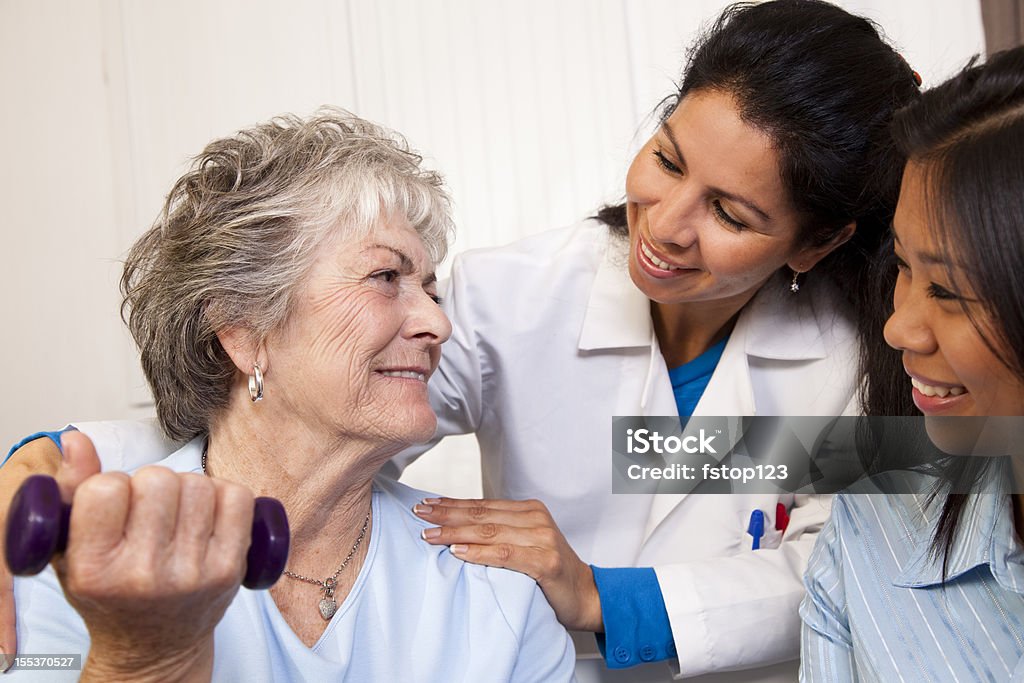 Anziani donna, terapia fisica. Terapista, medico, l'infermiere/a. Settore sanitario. Casa. - Foto stock royalty-free di 60-64 anni