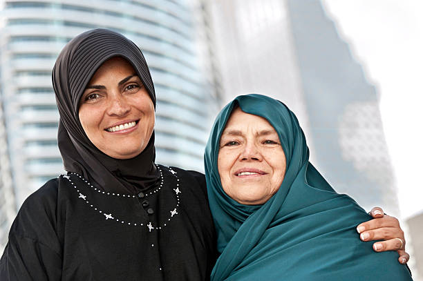 Muslim Mother and daughter Muslim Mature Woman posing with his Mother with buildings in the background moroccan woman stock pictures, royalty-free photos & images