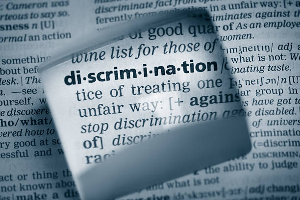 Definition "discrimination" The Dictionary definition of the word “discrimination” photo taken through magnifying glass from a page of a dictionary with selective focus. racism photos stock pictures, royalty-free photos & images