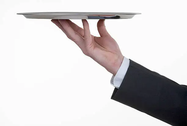 A butler serving with a silver tray your product