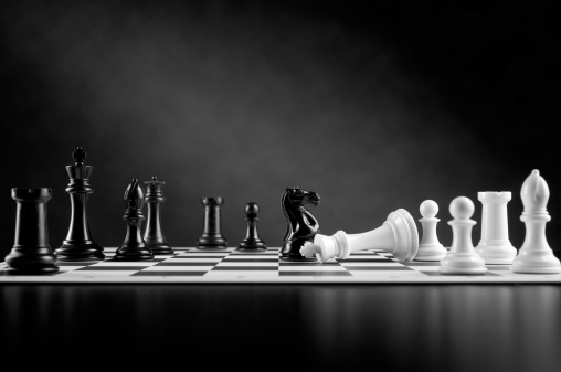 Checkmate move on chessboard, white king defeated, black and white.