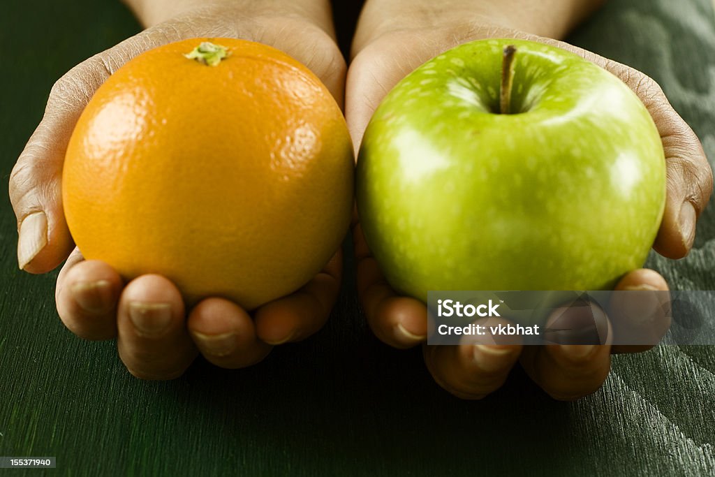 Apple and orange Comparing apple to orange exhibiting the idea of comparing two completely different things Apple - Fruit Stock Photo