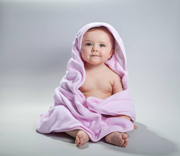 istock Baby girl with pink towel 155371972