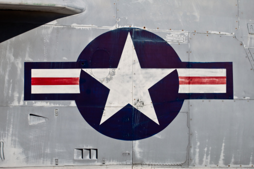 Faded US Air Force roundel on the side of a scraped military jet fighter plane